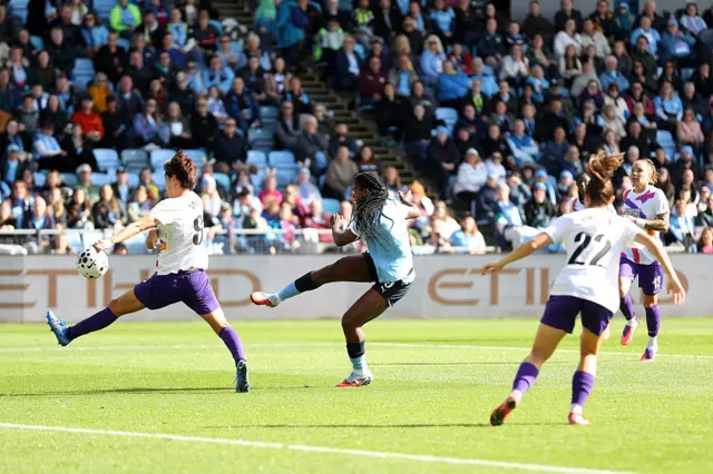 Khadija Shaw of Manchester City shoots as Saki Kumagai of London City Lionesses handles the ball, which resulted in a penalty during the Barclays Women's Super League match between Manchester City and London City Lionesses at Joie Stadium
