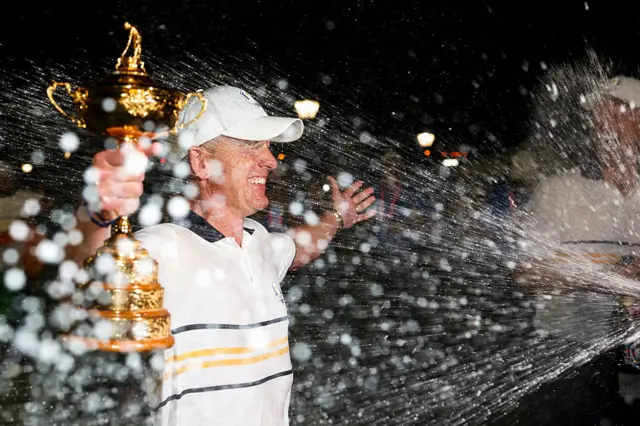 Luke Donald with the Ryder Cup, being sprayed with Champagne