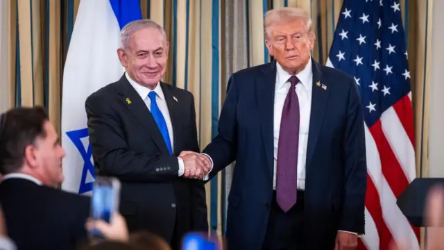 Israeli Prime Minister Benjamin Netanyahu shakes hands with US President Donald Trump