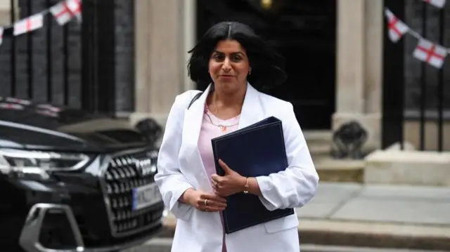 Shabana Mahmood outside Downing Street wearing a white jacket and holding a black folder