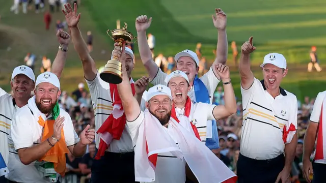 Tyrrell Hatton with the Ryder Cup, watched by Shane Lowry and Luke Donald