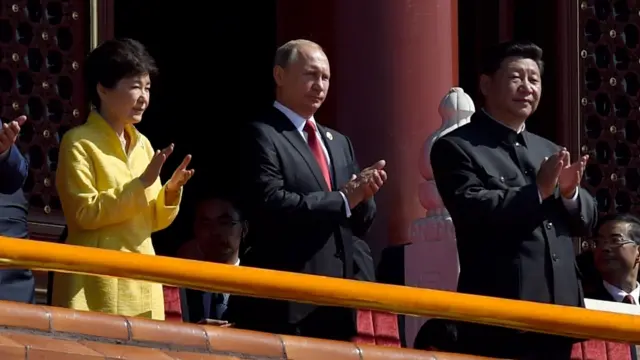 South Korea's President Park Geun-hye (L), Russia's President Vladimir Putin (Centre) and Chinese President Xi Jinping (R) applaud during a military parade in Tiananmen Square