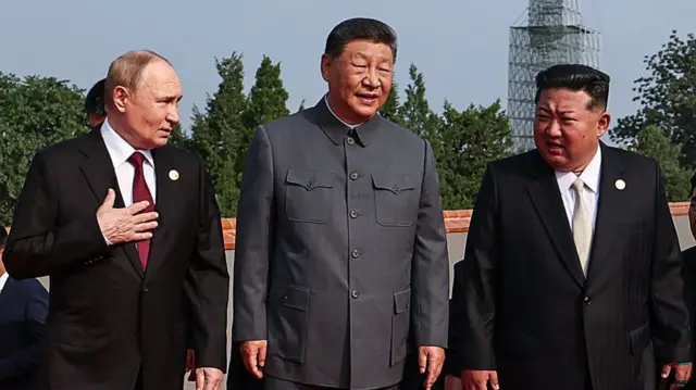 Kim Jong Un speaking to Xi and Putin