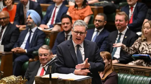 Prime Minister Keir Starmer gestures while taking questions in Parliament on 16 July