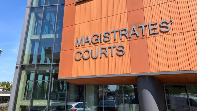 An orange-coloured building with the words Magistrates' Courts written on it