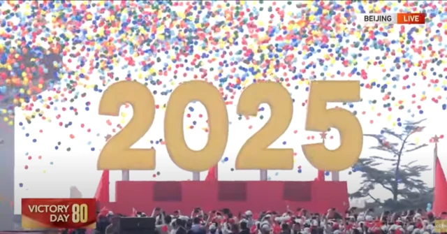 colourful balloons in the air behind a giant 2025 sign
