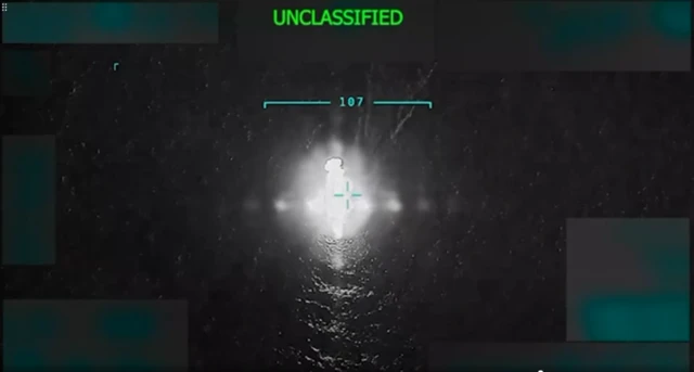 The boat on fire after the strike as seen in video released by US President Donald Trump