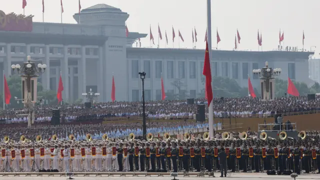 Members of Chinese People's Liberation Army (PLA) attend a flag-raising ceremony as China hosts a military parade