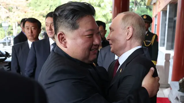 Kim Jong Un and Vladimir Putin share a hug