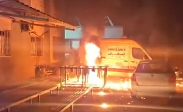 A screengrab from footage showing the ambulance on fire