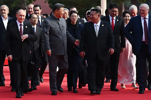 Russia's President Vladimir Putin walks alongside China's President Xi Jinping, North Korea's leader Kim Jong Un and Belarus' President Alexander Lukashenko on a red carpet