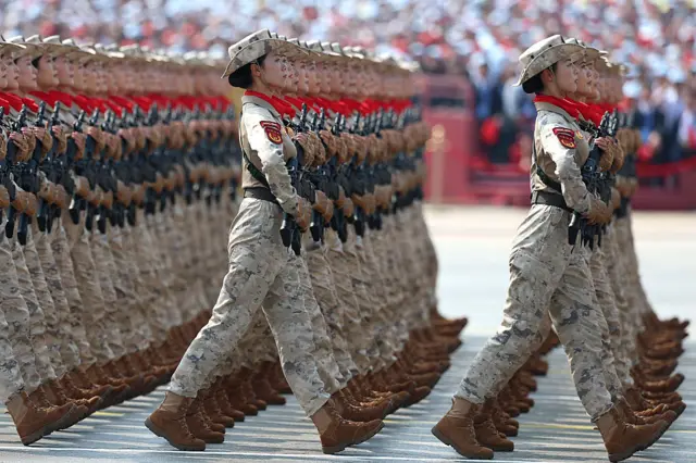 Female soldiers march during a military parade