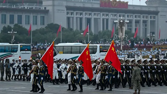 Soldiers holding Large Chinese flags as they march