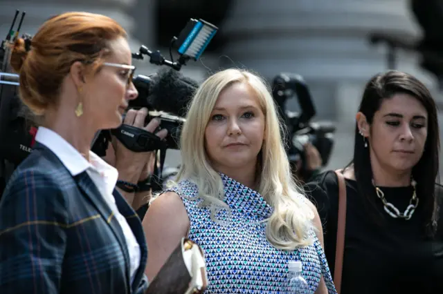 Virginia Giuffre, an alleged victim of Jeffrey Epstein, center, exits from federal court in New York