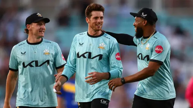Nathan Smith and Mitch Santner with Surrey's Chris Jordan