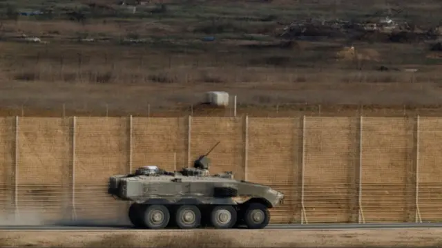 An Israeli armoured personnel carrier (APC) manoeuvres on Israeli side of the Israel-Gaza border