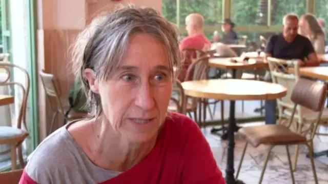 Susan Kennedy in a red and grey jumper and t-shirt