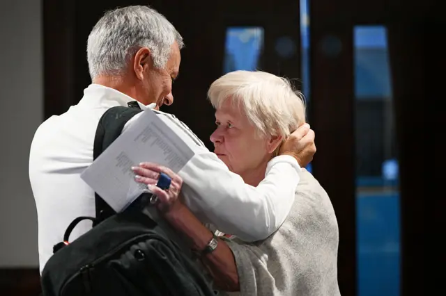 Jose Mourinho greets a member of Chelsea staff