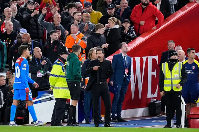Diego Simeone talking to the fourth official at Anfield