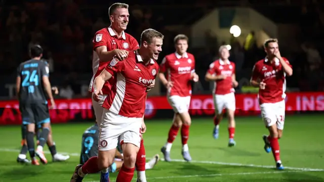 Emil Riis jumps on Rob Atkinson's back after the Bristol City defender scored against Ipswich