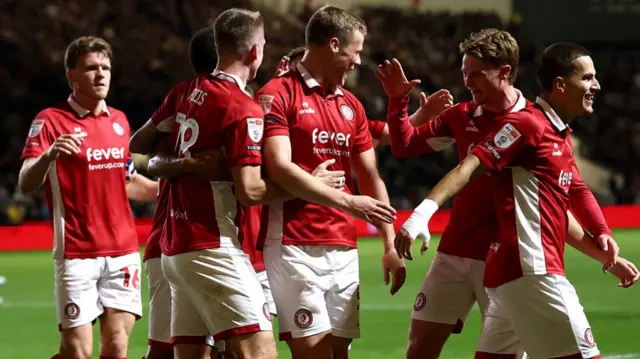 Bristol City players celebrate with Rob Atkinson