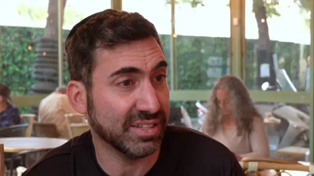 Man in a cafe speaking