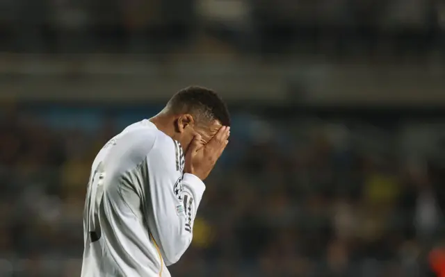 Mbappe covers his face after missing a chance