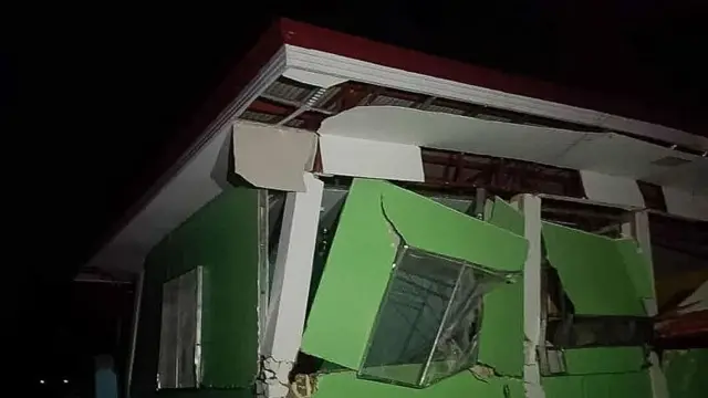 A broken building in green