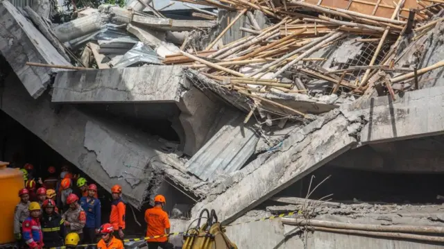 Rescuers search for survivors of a collapsed building at an Islamic boarding school in Sidoarjo, East Java
