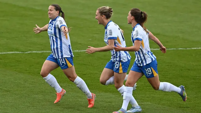 Fran Kirby of Brighton (L) celebrates with Maisie Symonds (centre) and Marisa Olislagers after op-ening the scoring during the Barclays Women's Super League match between Brighton & Hove Albion