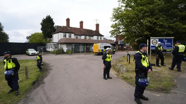Police stand outside the Epping Hotel