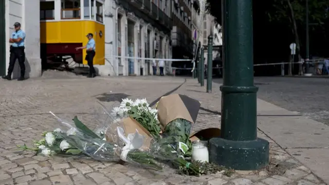 Flowers in tribute to the victims are pictured on the site of the Gloria funicular railway