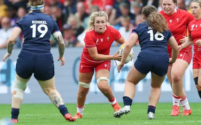 Alex Callender runs with the ball for Wales against Scotland
