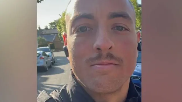 Nathan, a 28-year-old man, poses for a selfie