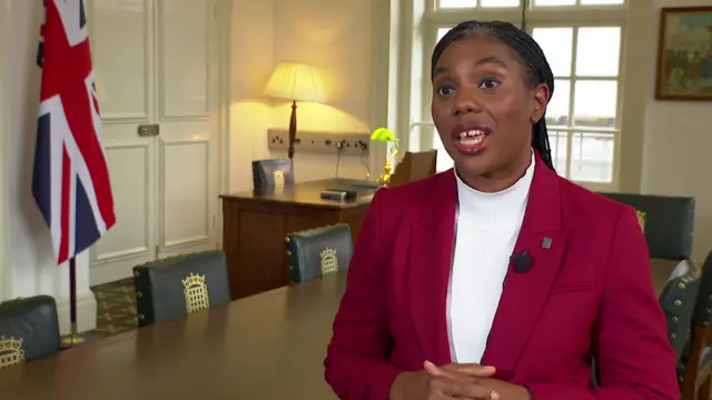 Kemi Badenoch speaks to the BBC in a red suit.