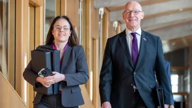 John Swinney and Kate Forbes walking along a corridor at Holyrood heading to the main chamber