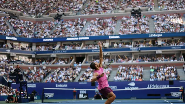 Carlos Alcaraz serves
