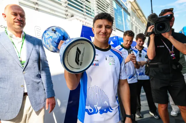 Isack Hadjar holds his replacement trophy in the build-up to the Italian Grand Prix