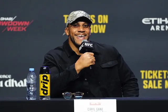 Ciryl Gane smiling with a UFC microphone in hand