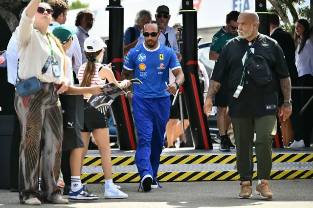 Lewis Hamilton wears blue Ferrari team kit
