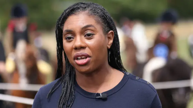 Badenoch, who has braids and wears a navy sweater, speaks to reporters from the Blakesley Show in Northamptonshire