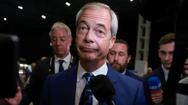 Farage speaking into a microphone