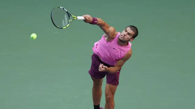 Carlos Alcaraz serves