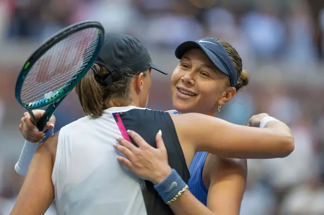 Amanda Anisimova of the United States and Iga Swiatek of Poland embrace