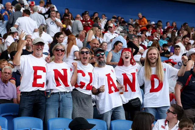 England fans wear shirts with individual letters to spell out 'England'