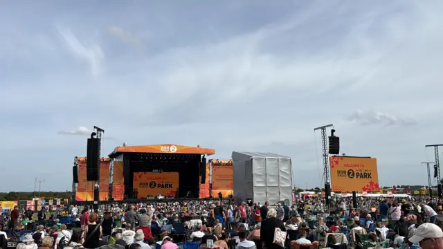 A general view of the Radio 2 in the Park festival. A large stage can be seen in the distance with various screens dotted around the site.