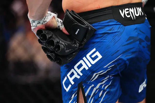 Paul Craig takes off his UFC gloves