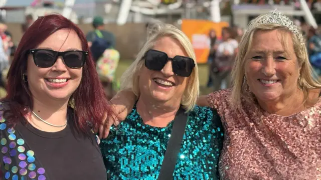 Rachel Willock, Jayne Owles and Kathryn Clark are all arm in arm and wearing sparkling tops.