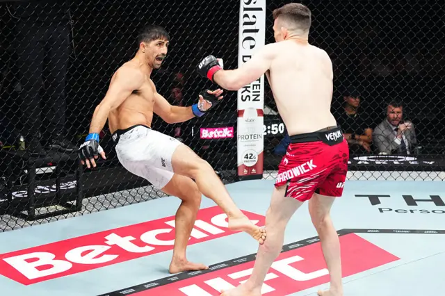 Kaue Fernandes kicking Harry Hardwick in the calf