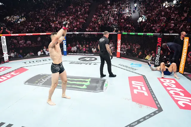 Paul Craig is on the canvas with the referee as Modestas Bukauskas celebrates